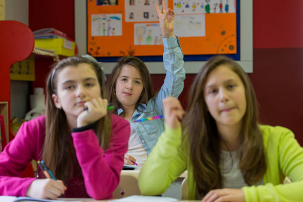 istock Schoolgirl raising arm up 926502816