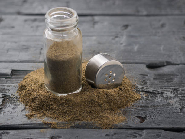 istock An open jar of ground pepper on a dark rustic table. 926507102