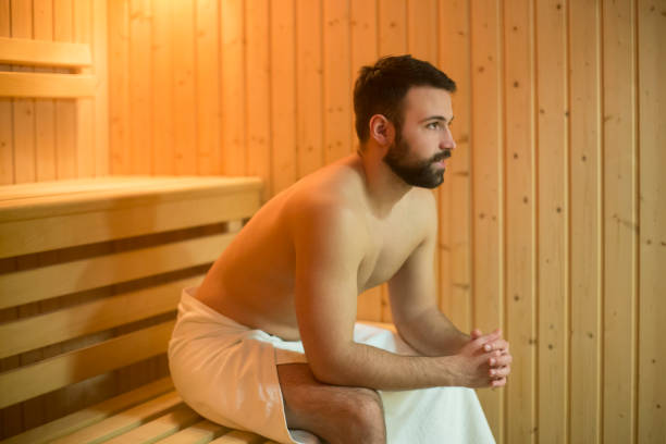 istock Young man relaxing in a Finnish sauna 926509034