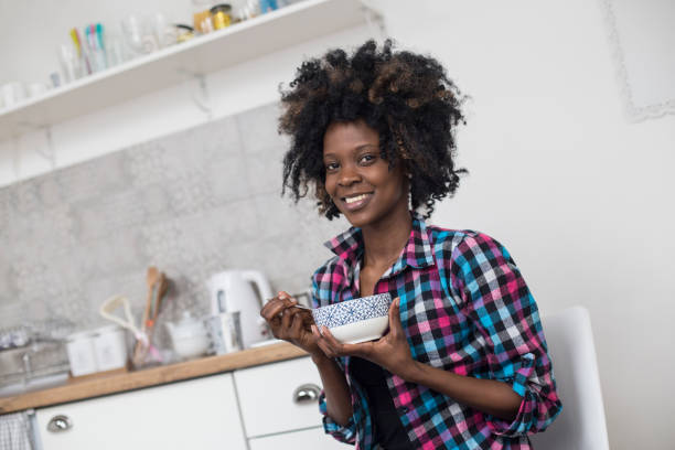 istock Young woman eating breakfast cereal 926510084