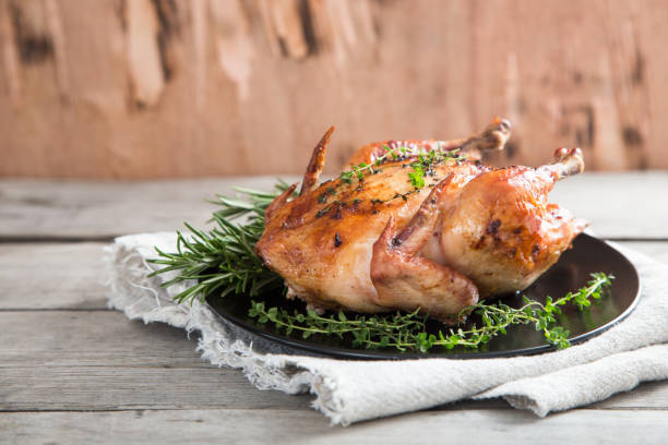 istock Fried whole chicken with herbs over natural wood background. whole roasted chicken 926518192