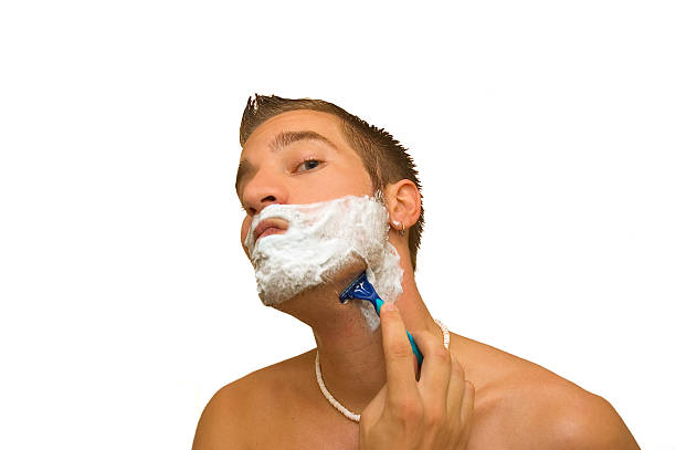 man shaving stock photo