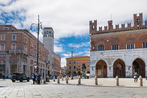 Piacenza, Emilia Romagna, northern Italy - Aprilt 20, 2017: City center with piazza Cavalli (square horses), palazzo Gotico (gothic palace - XIII century), equestrian monument and palazzo dei Mercanti (merchants' palace - XVII century) at the main square of Piacenza on a beautiful day with blue sky