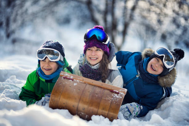istock Kids playing with toboggan in winter 926526946