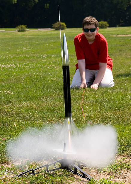 Young kid preparing to launch a rocket stock photo