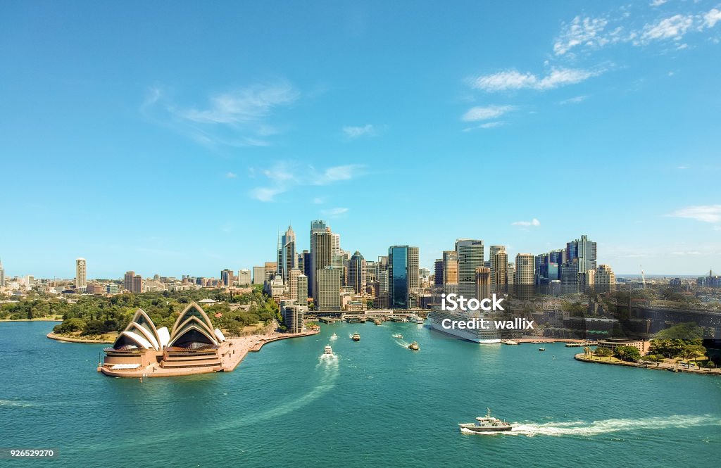 Stunning wide angle aerial drone view of the Sydney Harbour with the Opera House, a cruise ship and many skyscrapers in the background. Taken near the suburb of Kirribilli. New South Wales, Australia. Sydney Stock Photo