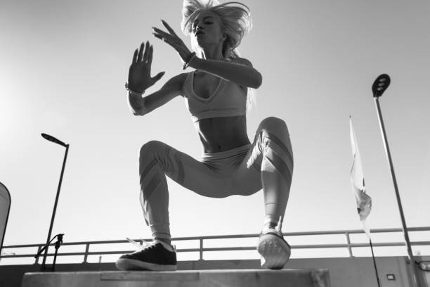 istock Fit young woman doing box jumping. 926529388