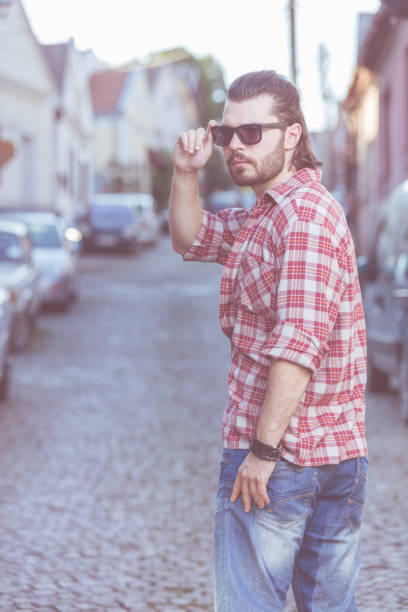 istock Handsome young guy posing on the street. 926529582