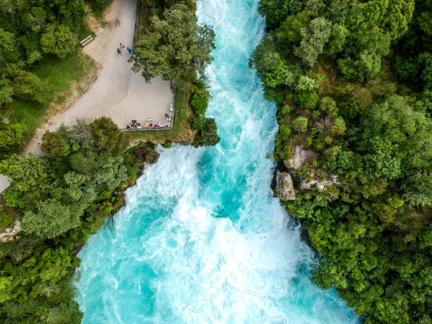 Stunning aerial wide angle drone view of Huka Falls waterfall in Wairakei near Lake Taupo in New Zealand. The waterfall is part of the Waikato River and is a major tourist attraction. stock photo