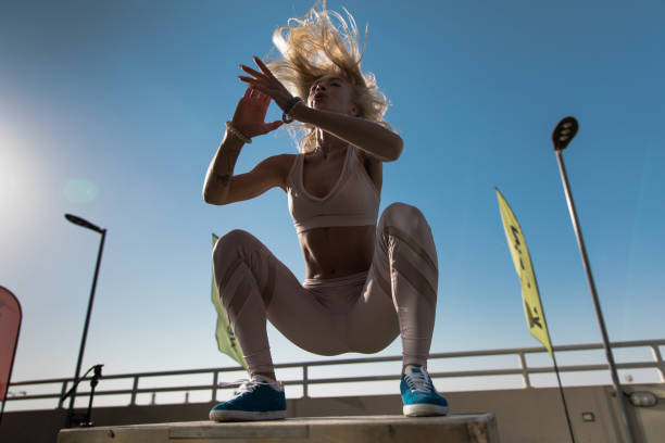 istock Fit young woman doing box jumping. 926529780