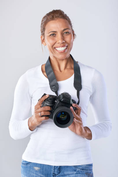 istock Confident woman holding DSLR camera 926529954