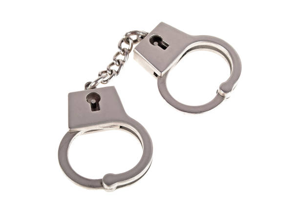 istock Silver handcuffs on white background 926530172