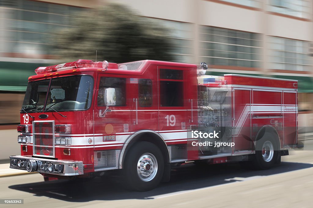 A unfocused image of a classic red fire engine red fire truck rushing down street Fire Engine Stock Photo