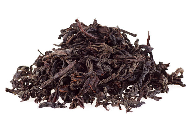 istock Black dry tea leaves isolated on white background 926533822