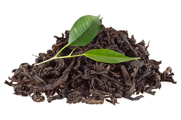 istock Tea leaves with dry black tea on a white background 926533848