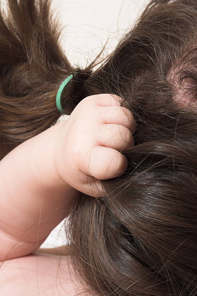 istock baby grabbing hair 92653434