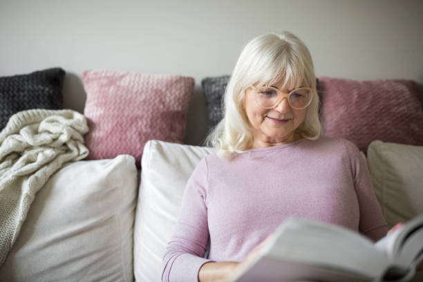 istock Content senior lady reading book at home 926539100