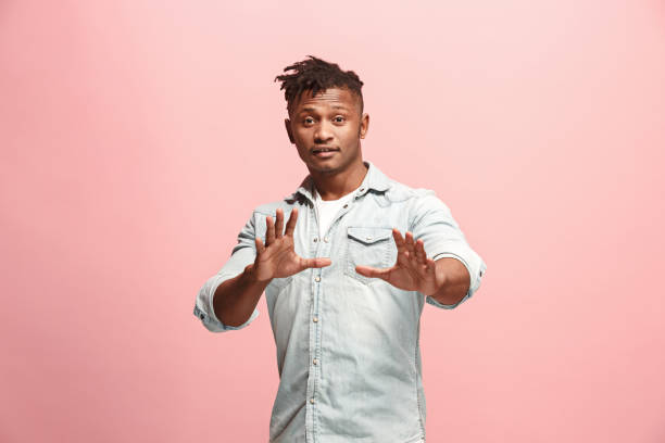 istock Handsome man looking suprised isolated on pink 926539152