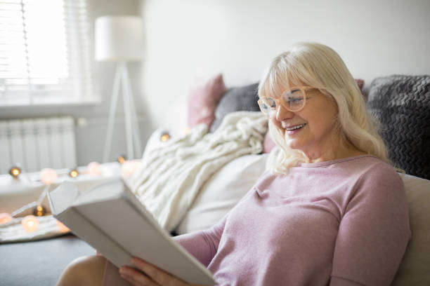 istock Happy senior lady enjoying good book 926539276