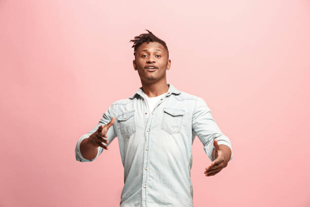 istock Handsome man looking suprised isolated on pink 926539492