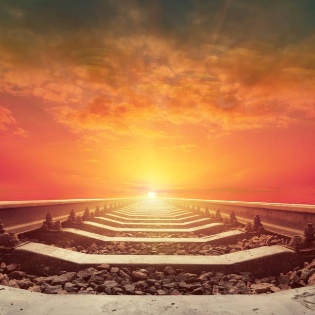 istock orange sunset in clouds and railway closeup 926539774