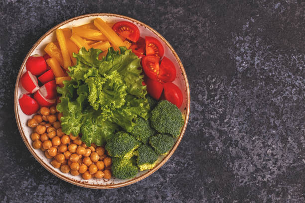istock Bowl with vegetables and chickpea on a dark  background. 926542734