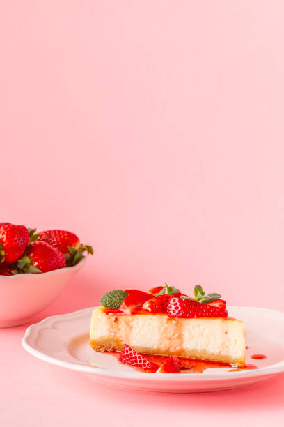 istock homemade cheesecake with strawberries on pink background 926543564