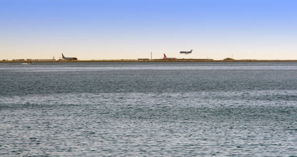 istock airplane landing near the sea 926543624