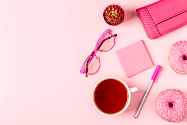 istock Cup of tea with donuts on a pink pastel background 926543752