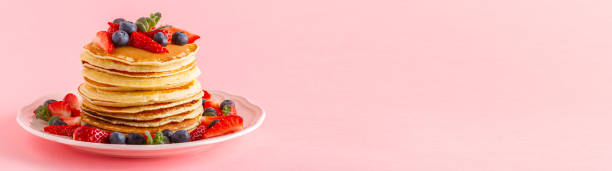 istock Pancakes with berries on a bright pastel background 926543852