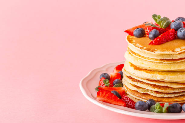 istock Pancakes with berries on a bright pastel background 926546020