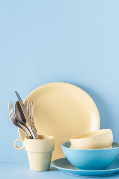 istock Crockery and cutlery on a blue pastel background 926546156