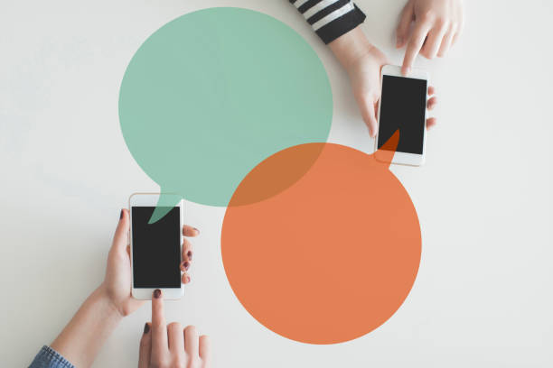 istock Two hand mobile phones sending message each other 926551124