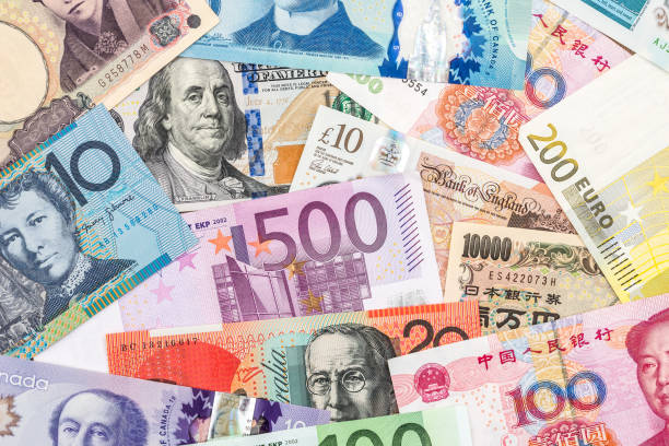 istock scattered collection of money from different countries 926553580