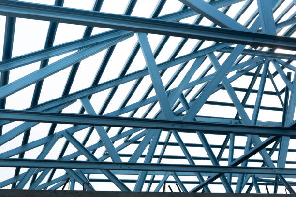 istock Structure of steel roof frame for building construction isolated on blue sky background. 926553778