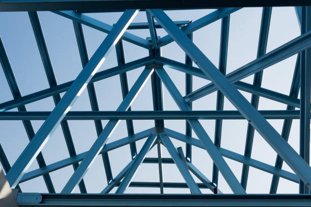 istock Structure of steel roof frame for building construction isolated on blue sky background. 926553880
