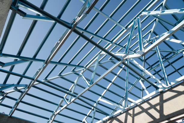istock Structure of steel roof frame for building construction isolated on blue sky background. 926554372