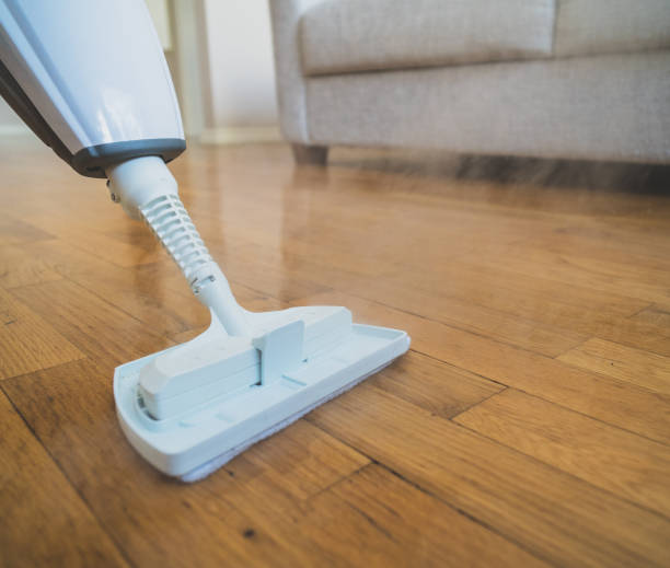 istock Cleaning the floor with a dry steam cleaner. 926558084