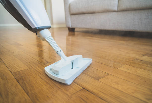 istock Cleaning the floor with a dry steam cleaner. 926558112