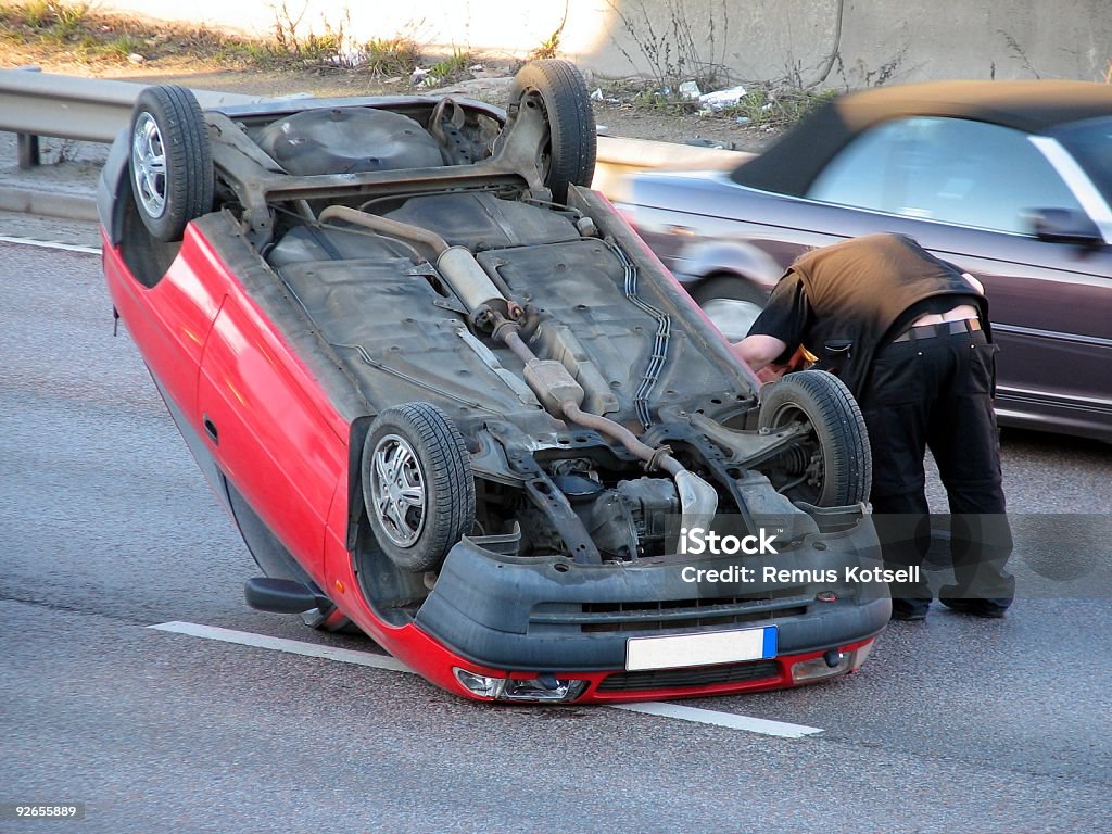 Car turned upside down in an accident Car accident, the person in the car survived and was brought to hospital after the crash. Upside Down Stock Photo