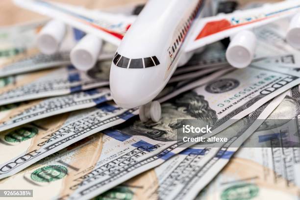 Airplane On Dollar Bills Close Up Stock Photo - Download Image Now - Currency, Airplane, Tax