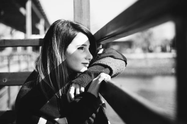 istock on a cold winter day alone lady is sitting on a pier 926566086