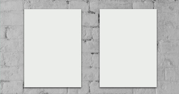 Two white sheets with empty space for text on brick wall. stock photo