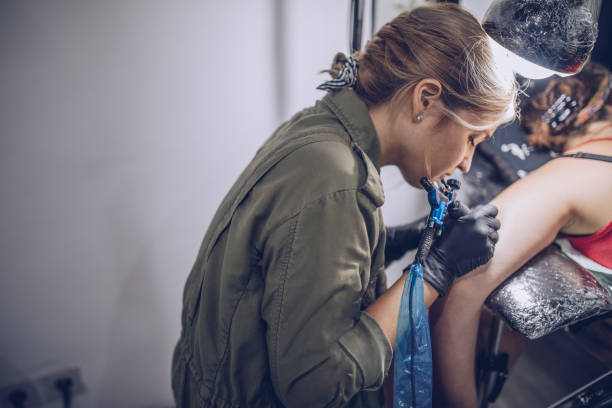 istock Girl tattoo artist working 926570484
