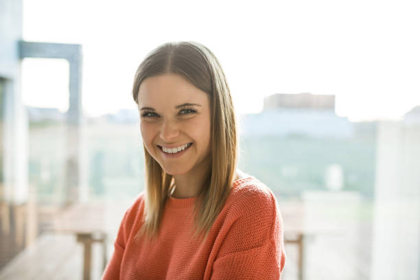 istock Pretty young woman in red sweater laughing 926570808