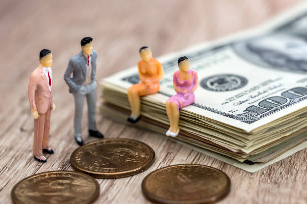 istock dollars and coins and mini people 926571410