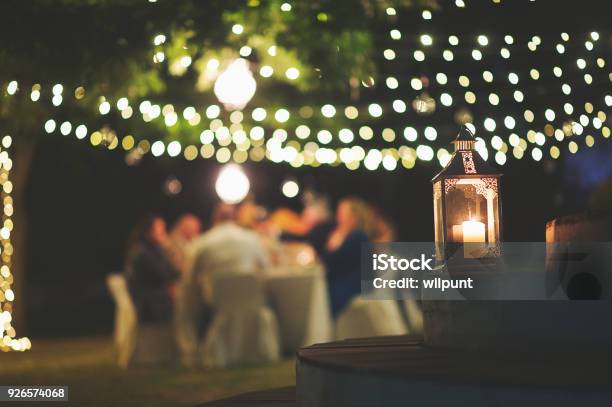 Candle And String Lights Outdoor Dinner Stock Photo - Download Image Now - Outdoors, Party - Social Event, Christmas