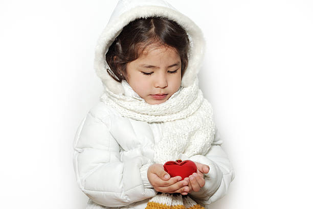 The little girl toy heart on a light background stock photo