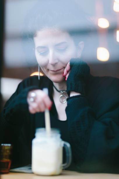 istock Woman drinking smoothie on cafe 926578632