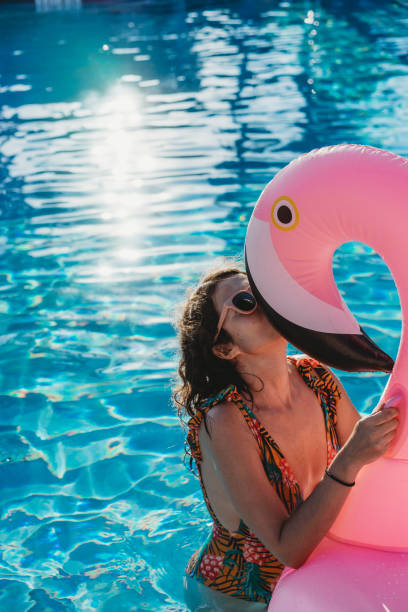 istock Woman with flamingo inflatable during vacation 926579976